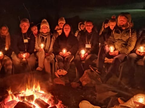 Meditating with lanterns around the fire