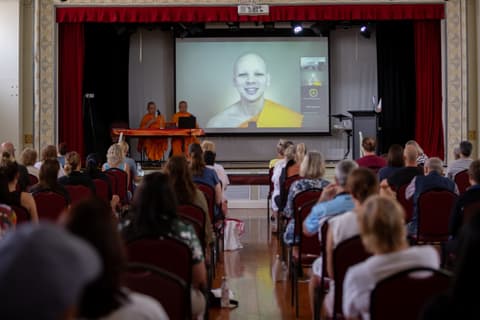 A guided meditation shown on the big screen in a hall