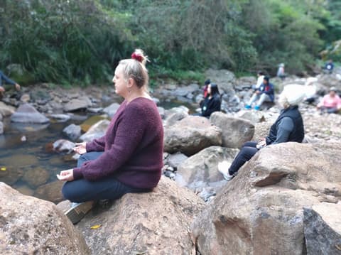 Meditating on a boulder by the water