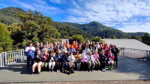 Group photo of participants and monks on the deck