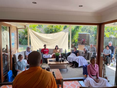 A monk teaching on the veranda
